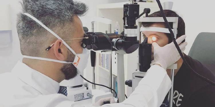 Diego Lopez Alcon examining a scleral lens fit in a young patient