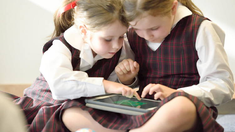 Two children studying at home with a tablet Two children studying at home with a tablet